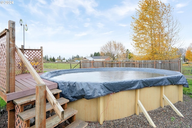 view of swimming pool with a wooden deck