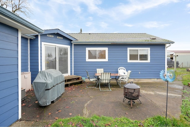 view of patio with a grill and an outdoor fire pit