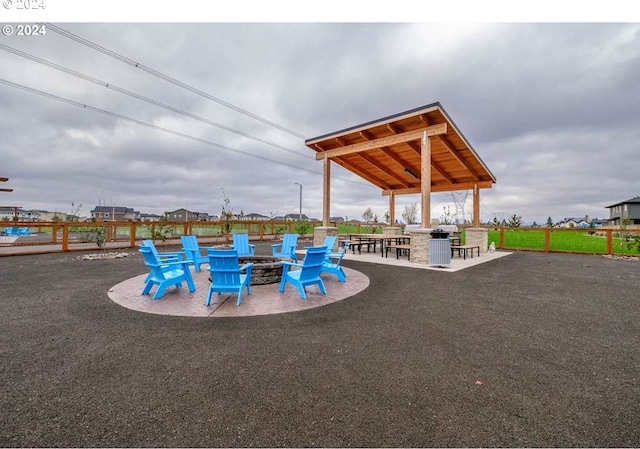 view of pool with a gazebo, a fire pit, and a patio