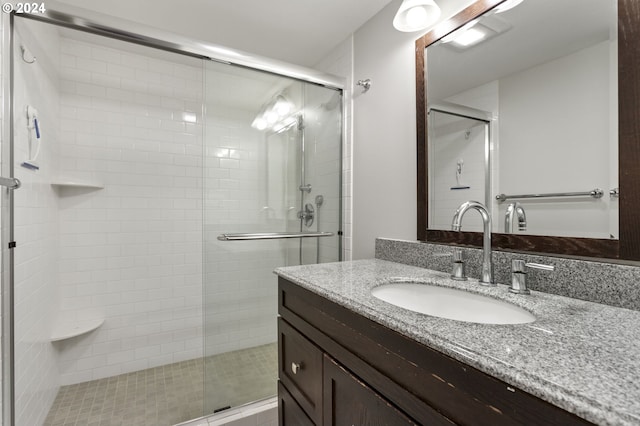 bathroom featuring walk in shower and vanity