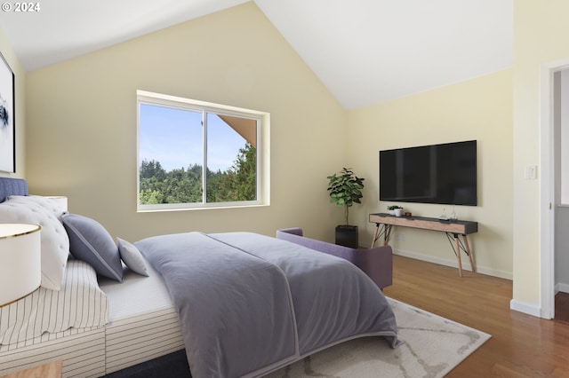 bedroom with lofted ceiling and dark hardwood / wood-style flooring