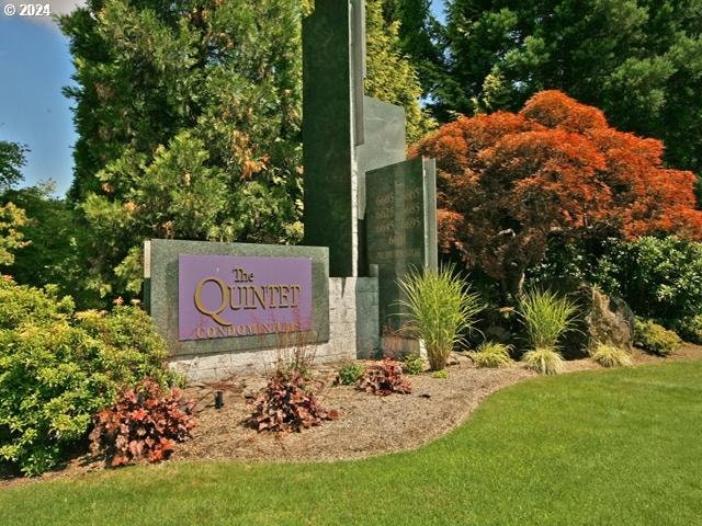 community / neighborhood sign with a lawn