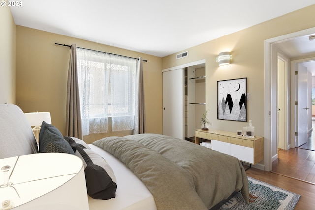 bedroom featuring wood-type flooring and a closet