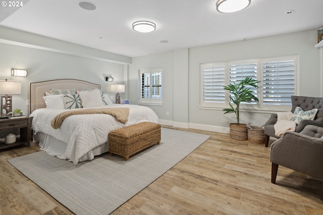 bedroom featuring baseboards and wood finished floors