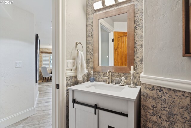 bathroom with hardwood / wood-style floors and vanity