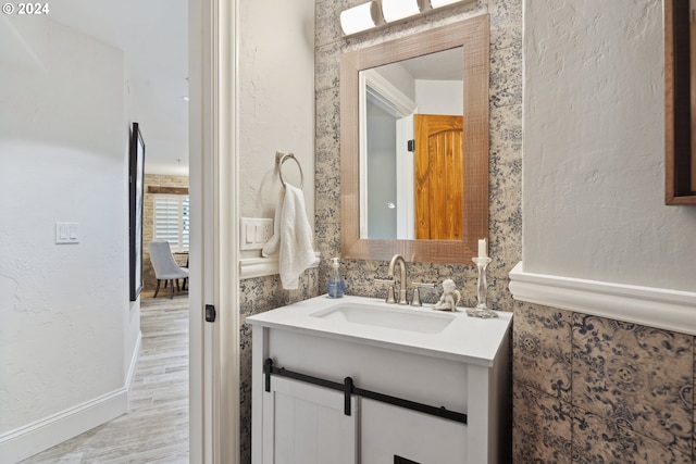 bathroom with vanity and wood finished floors