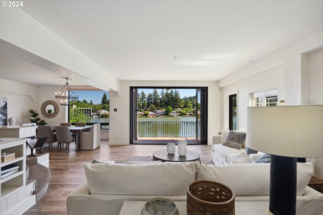 living room featuring wood finished floors and an inviting chandelier