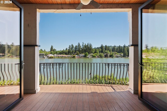 deck featuring a ceiling fan and a water view