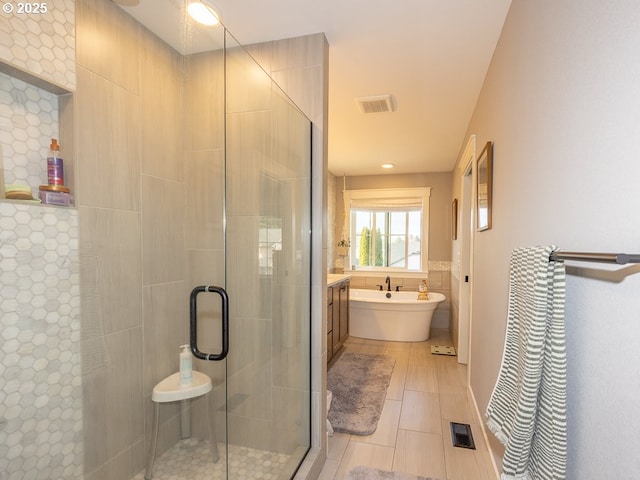 bathroom with plus walk in shower, tile walls, and tile patterned floors