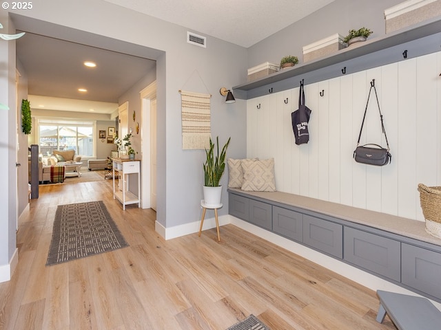 mudroom with light hardwood / wood-style floors