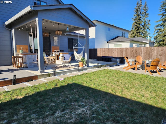 rear view of property with a yard and a patio