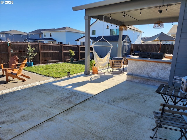 view of patio / terrace featuring a storage unit