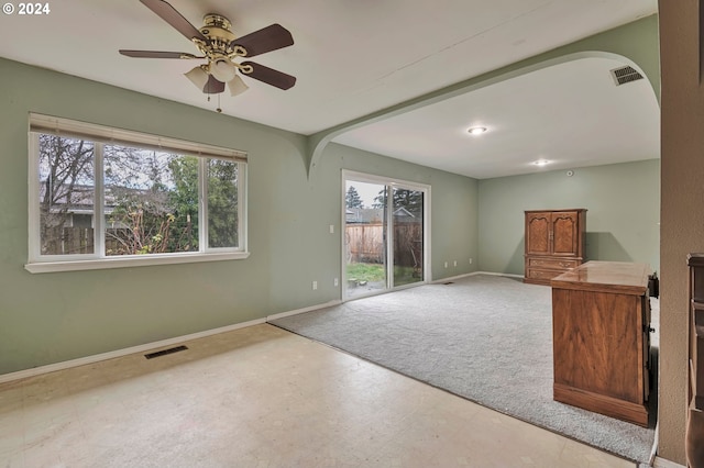 unfurnished living room with ceiling fan and a healthy amount of sunlight