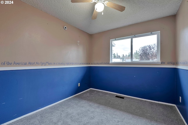 unfurnished room featuring a textured ceiling, carpet floors, and ceiling fan