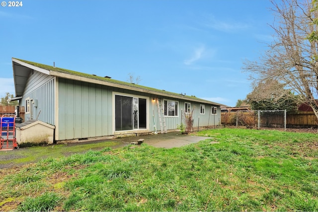 rear view of house with a yard