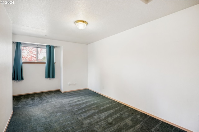 carpeted spare room with a textured ceiling