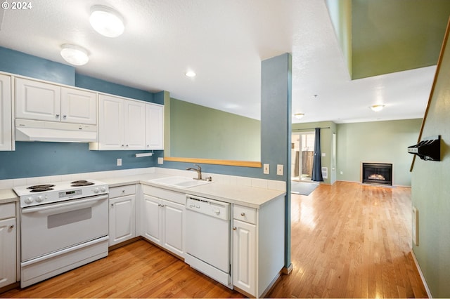 kitchen with light hardwood / wood-style flooring, sink, white cabinets, a textured ceiling, and white appliances