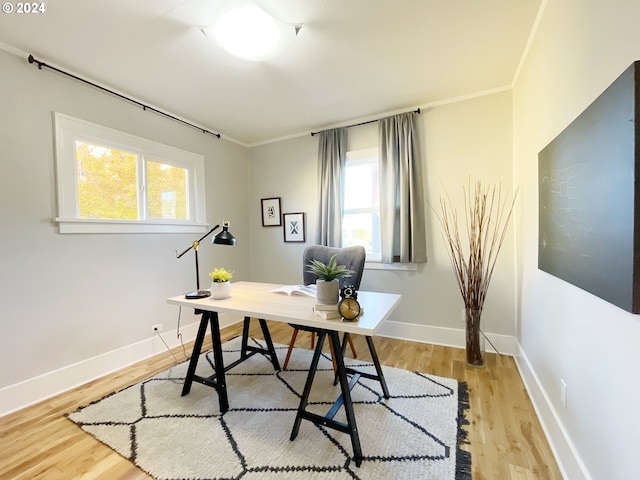 1035 NE Killingsworth St, Portland, OR 97211 - home office with light wood finished floors, baseboards, and crown molding