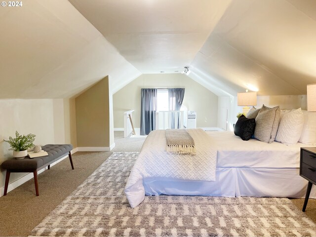 1035 NE Killingsworth St, Portland, OR 97211 - bedroom with carpet floors, vaulted ceiling, and baseboards