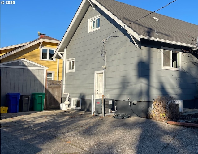 1035 NE Killingsworth St, Portland, OR 97211 - rear view of house with a storage shed and a shingled roof