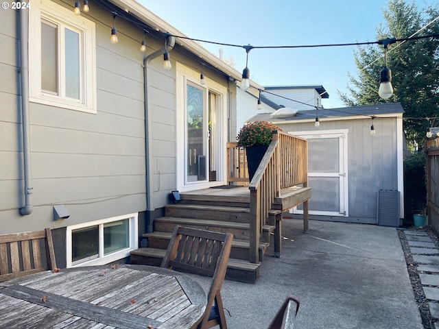 1035 NE Killingsworth St, Portland, OR 97211 - view of patio / terrace with an outdoor structure and a storage unit