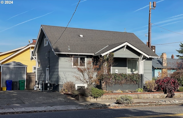 1035 NE Killingsworth St, Portland, OR 97211 - view of front facade featuring a shingled roof and central air condition unit