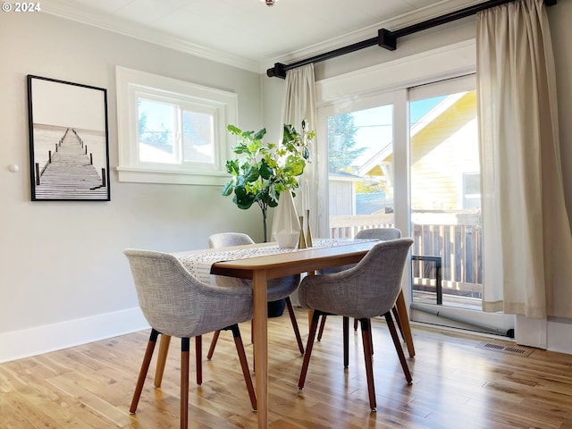 1035 NE Killingsworth St, Portland, OR 97211 - dining room featuring crown molding, wood finished floors, and baseboards