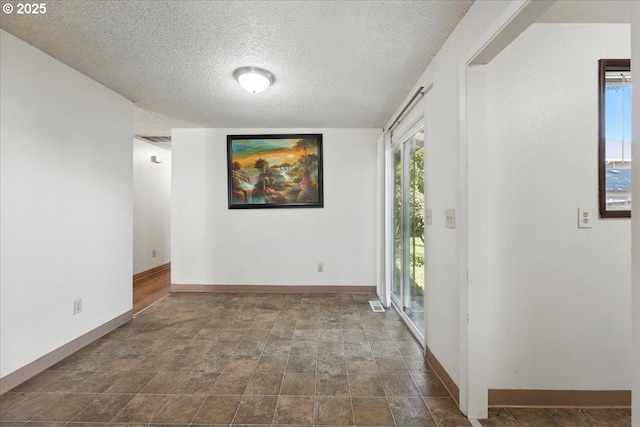 18495 SW Springfield St, Beaverton, OR 97078 - foyer featuring a textured ceiling, stone finish flooring, and baseboards