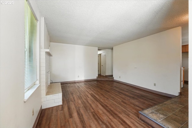 18495 SW Springfield St, Beaverton, OR 97078 - unfurnished living room featuring wood finished floors, a textured ceiling, and baseboards