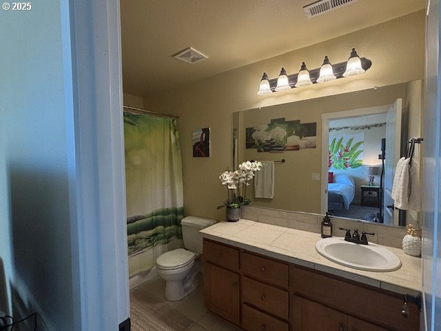 834 NW 3rd Ave, Canby, OR 97013 - bathroom featuring vanity, connected bathroom, toilet, a shower with curtain, and tile patterned floors