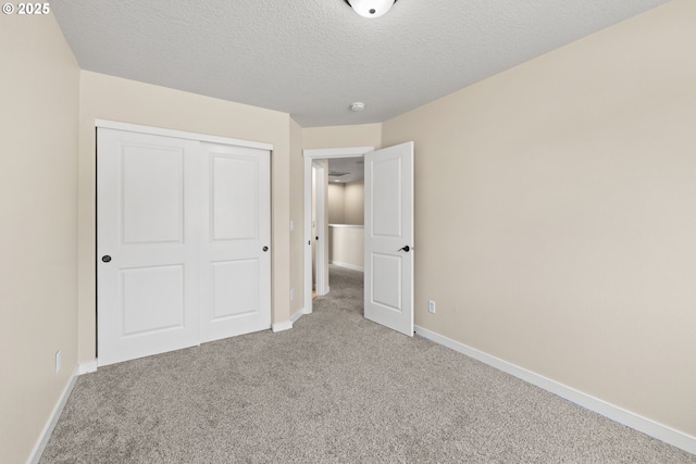 834 NW 3rd Ave, Canby, OR 97013 - unfurnished bedroom featuring carpet, a closet, and a textured ceiling