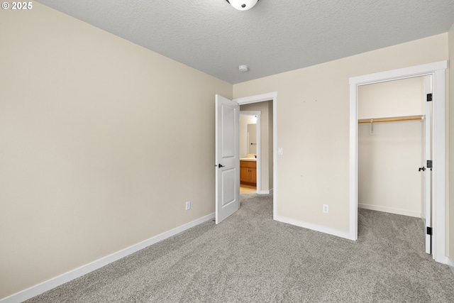 834 NW 3rd Ave, Canby, OR 97013 - unfurnished bedroom featuring light colored carpet, a spacious closet, a closet, and a textured ceiling