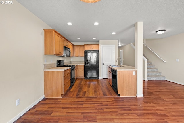 834 NW 3rd Ave, Canby, OR 97013 - kitchen with black appliances, light countertops, dark wood-style floors, recessed lighting, and a textured ceiling