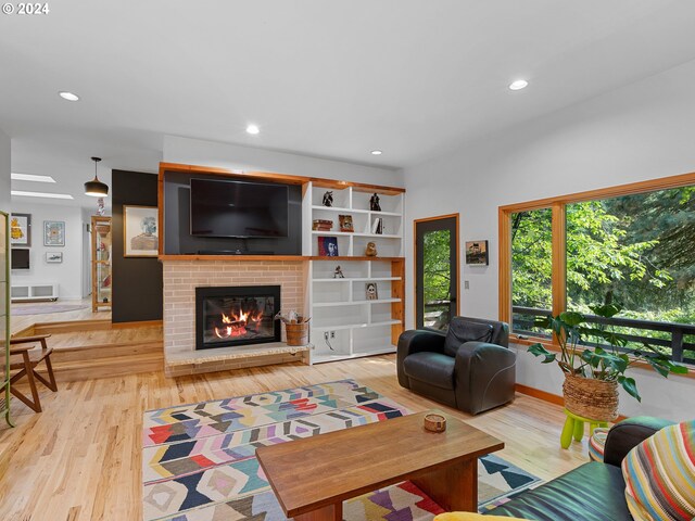 living room with light hardwood / wood-style floors and a fireplace