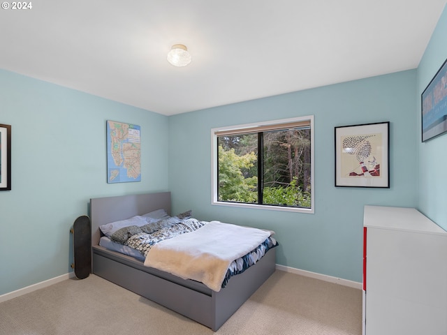 bedroom featuring light carpet