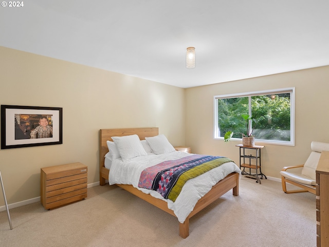 bedroom featuring light colored carpet