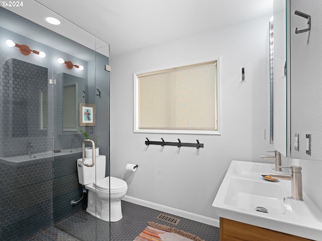 bathroom featuring tile patterned flooring, vanity, toilet, and a shower with door