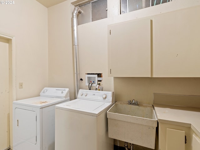 laundry room with cabinets, sink, and independent washer and dryer