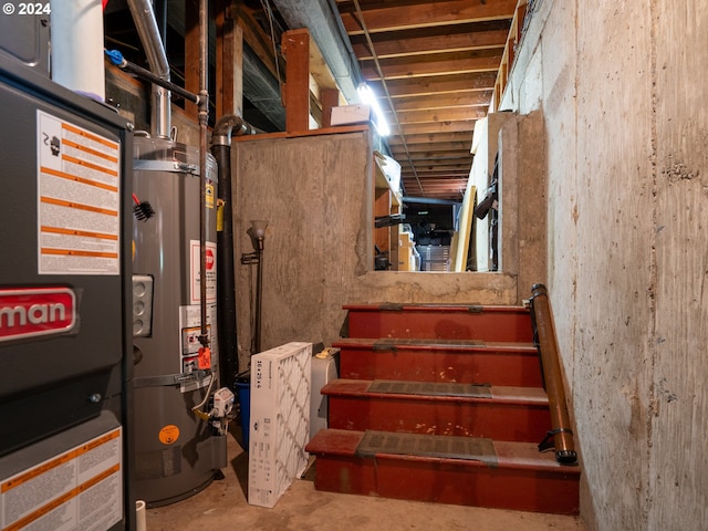 stairs with gas water heater and concrete floors