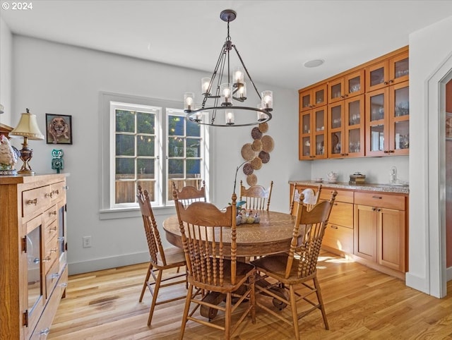 dining space featuring a notable chandelier and light hardwood / wood-style floors