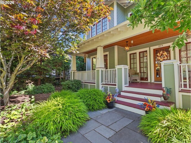 view of exterior entry with a porch