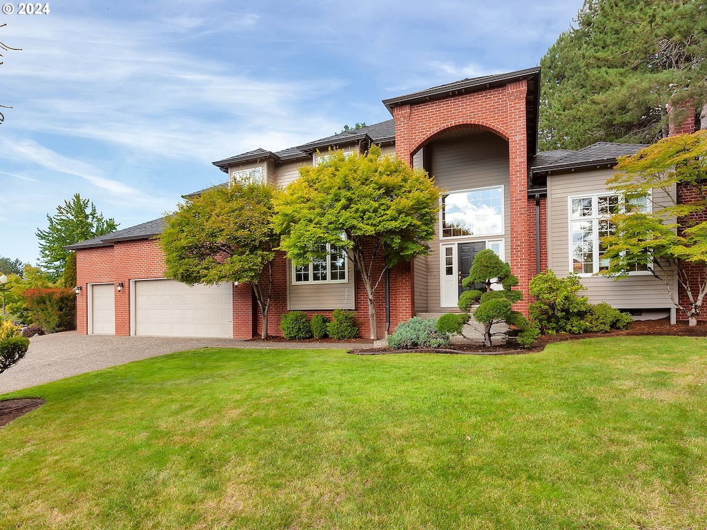 view of front of home featuring a garage and a front lawn