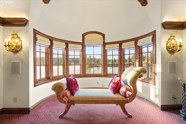 living area featuring a water view and baseboards