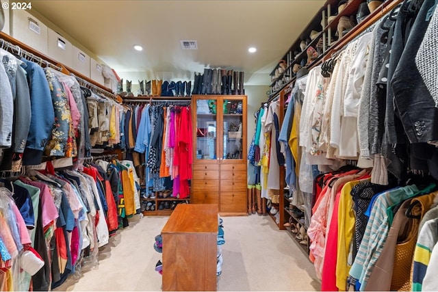 walk in closet with light carpet and visible vents