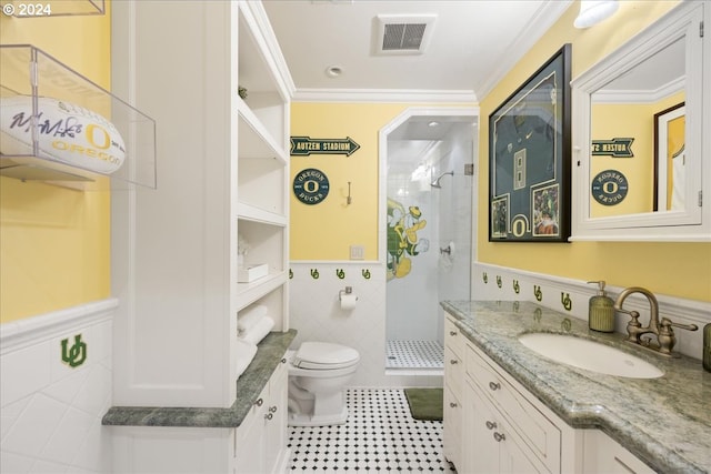 bathroom featuring visible vents, toilet, crown molding, a shower stall, and tile walls