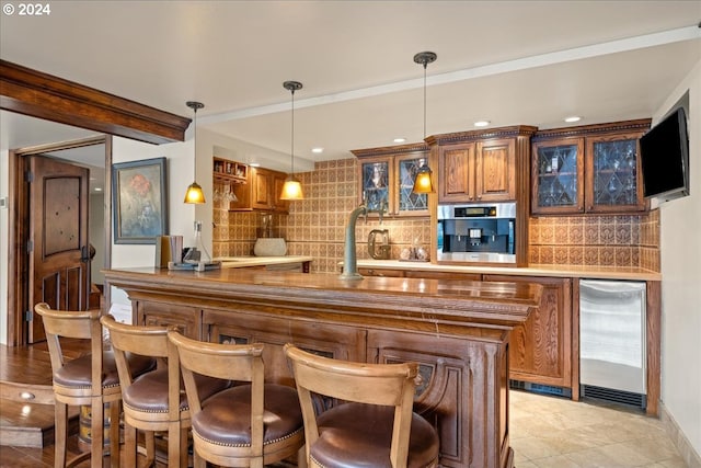 bar with refrigerator, pendant lighting, indoor wet bar, and backsplash