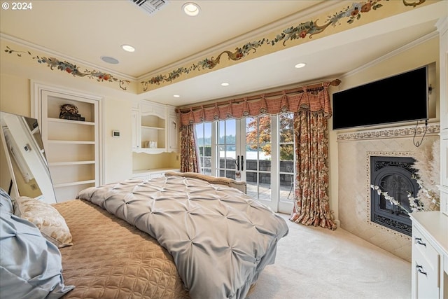 bedroom with ornamental molding, french doors, light carpet, access to exterior, and a high end fireplace