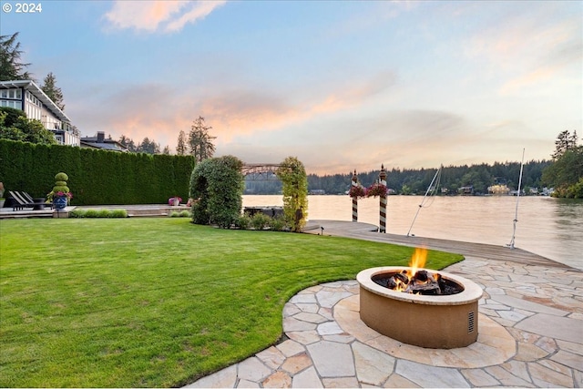 yard at dusk featuring a fire pit and a patio area