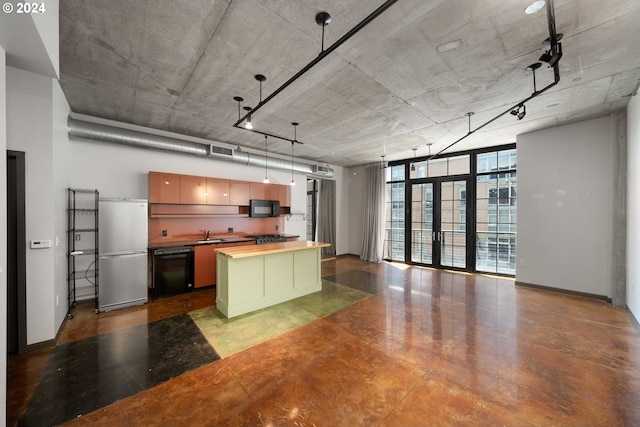 kitchen with butcher block counters, floor to ceiling windows, a center island, sink, and black appliances