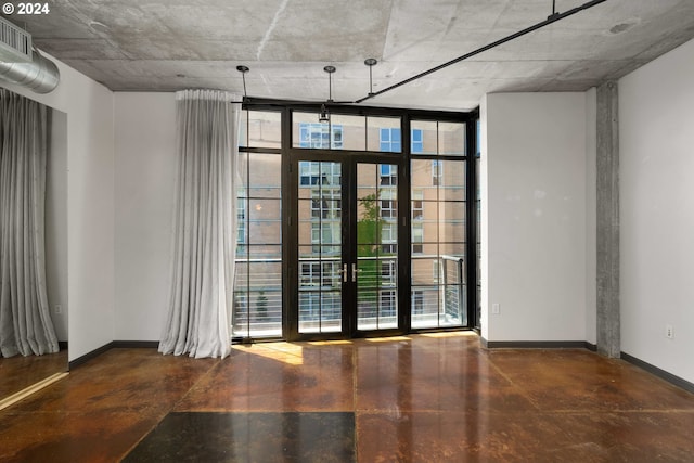 empty room with french doors and expansive windows